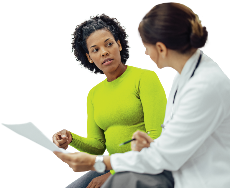 Actor portrayals of female patient in green shirt talking to female doctor, pointing to Doctor Discussion Guide